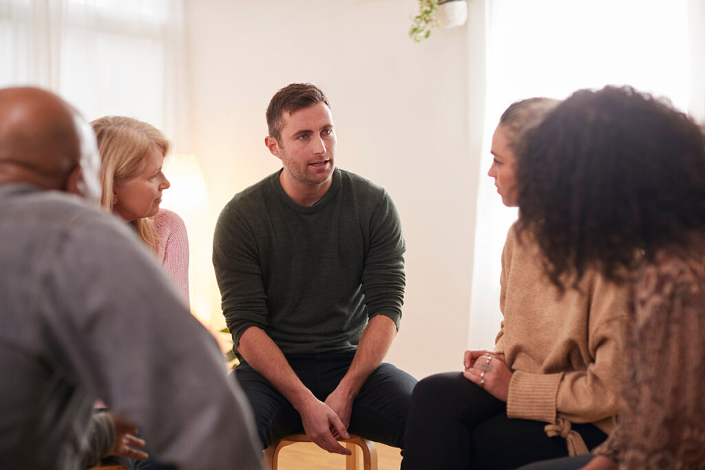 A therapist discusses mental health programs with prospective mental health treatment seekers in Boston.